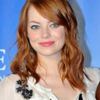 Emma Stone Medium Brown Wavy Hairstyle with Side Bangs