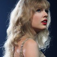 Taylor Swift Curly Hairstyle with Soft Wispy Bangs