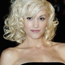 Gwen Stefani Medium Blonde Curly Hairstyle with Bangs