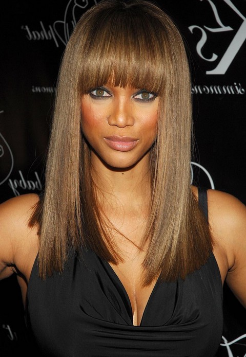 long sleek hairstyle with blunt bangs for black women Tyra Banks hairstyle