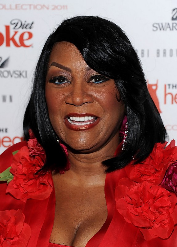Patti LaBelle Medium Layered Straight Hairstyle with Bangs