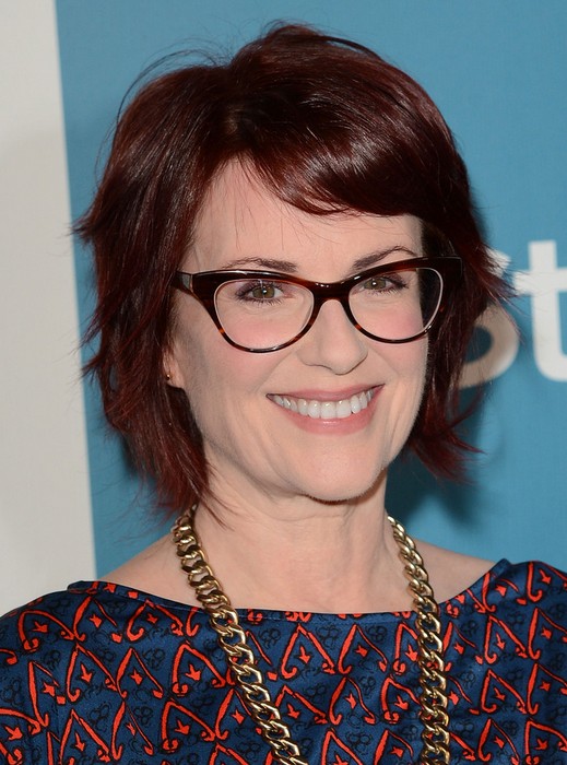 Megan Mullally Layered Short Red Haircut With Side Swept Bangs For