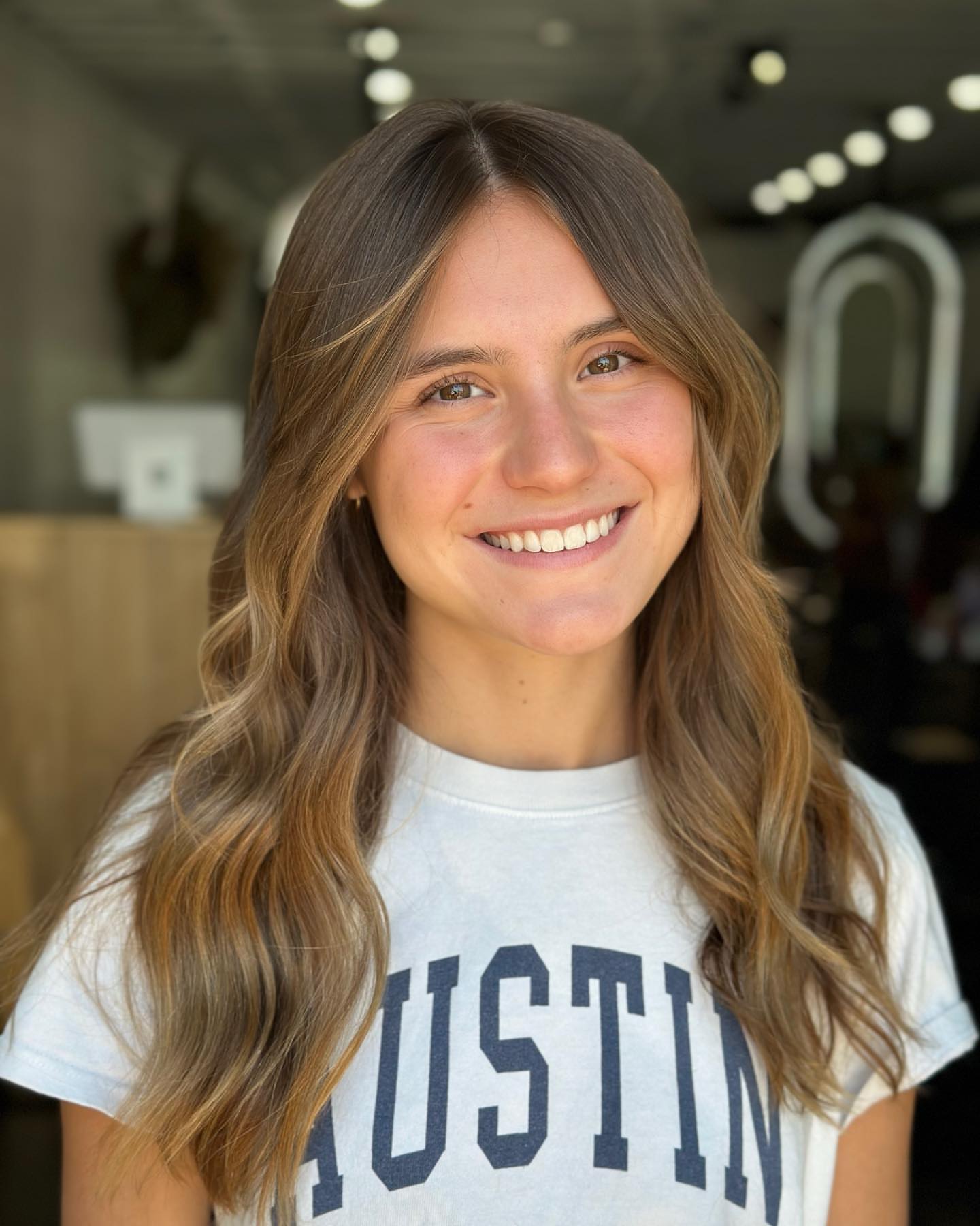 Shiny Balayage hair with curtain bangs